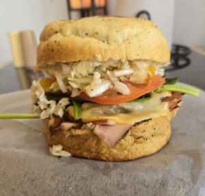 House-smoked turkey pastrami, bacon, smoked Gouda cheese, sweet pepper coleslaw, garlic aioli. spinach, tomato & onion on your choice of bread